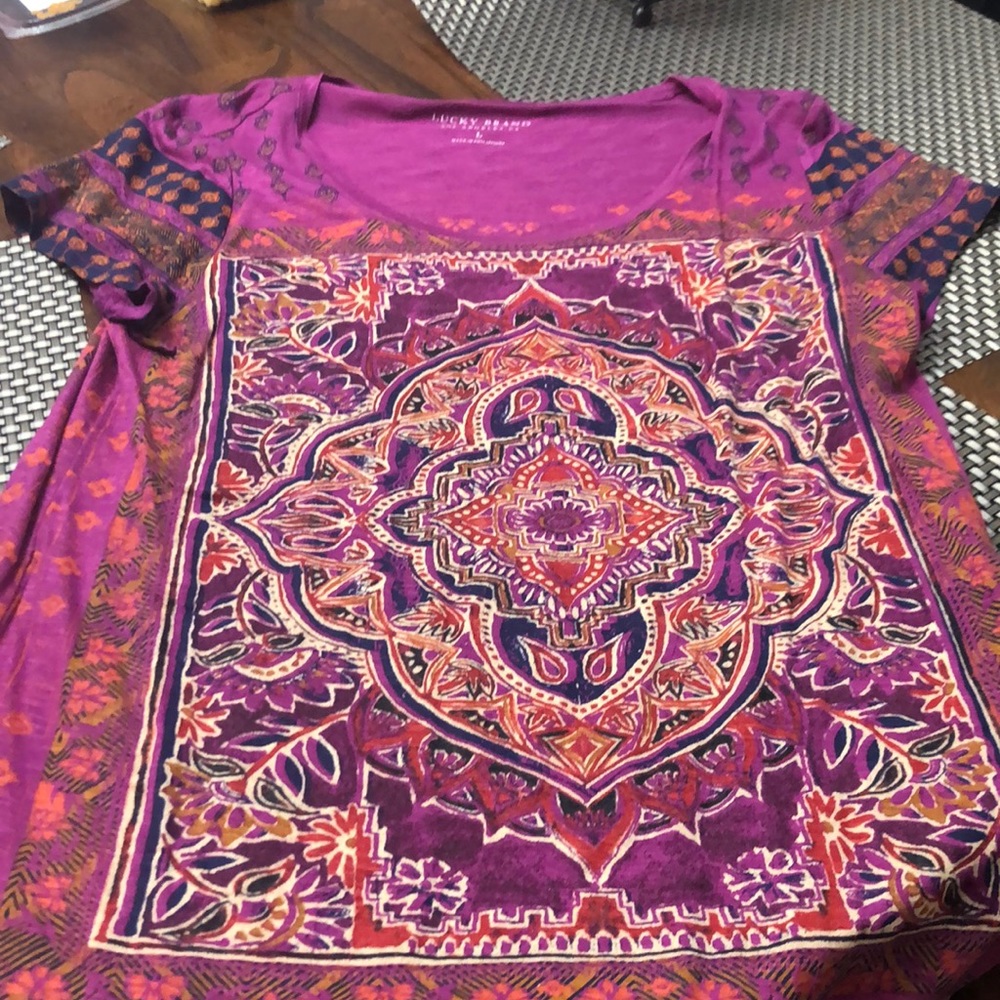 SLIGHTLY LOWER IN THE BACK AT BOTTOM OF SHIRT